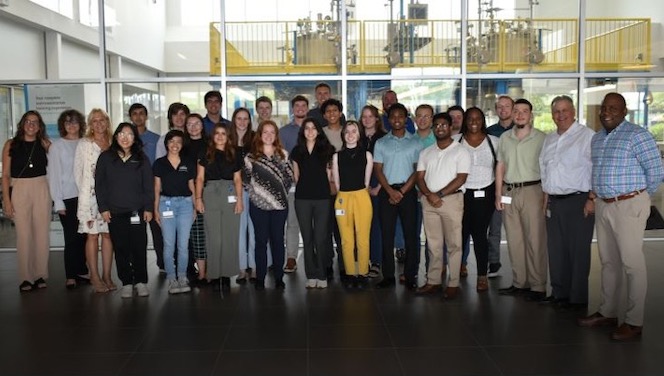 Reem Abdelaziz - Reem Delziz standing in Endress+Hauser facility with intern class